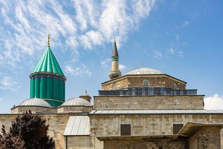A mosque with multiple domes and a minaret. 3