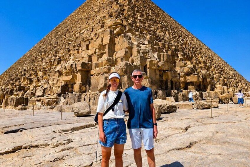 A large pyramid structure with tourists in front. 5