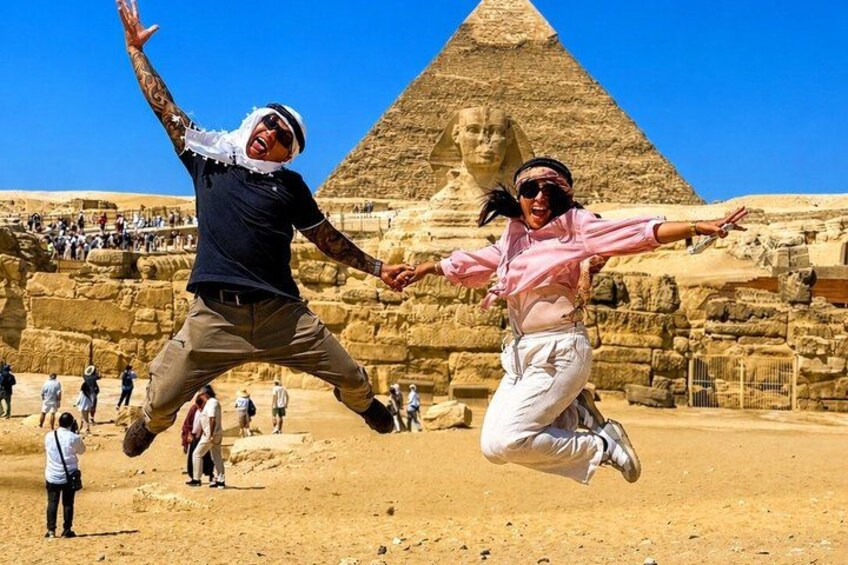 Two people jumping in front of the Great Pyramid of Giza. 3
