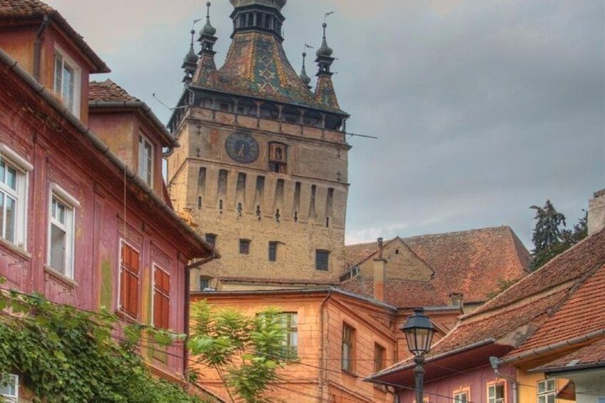 A historic building with a clock tower, surrounded by traditional architecture. 1