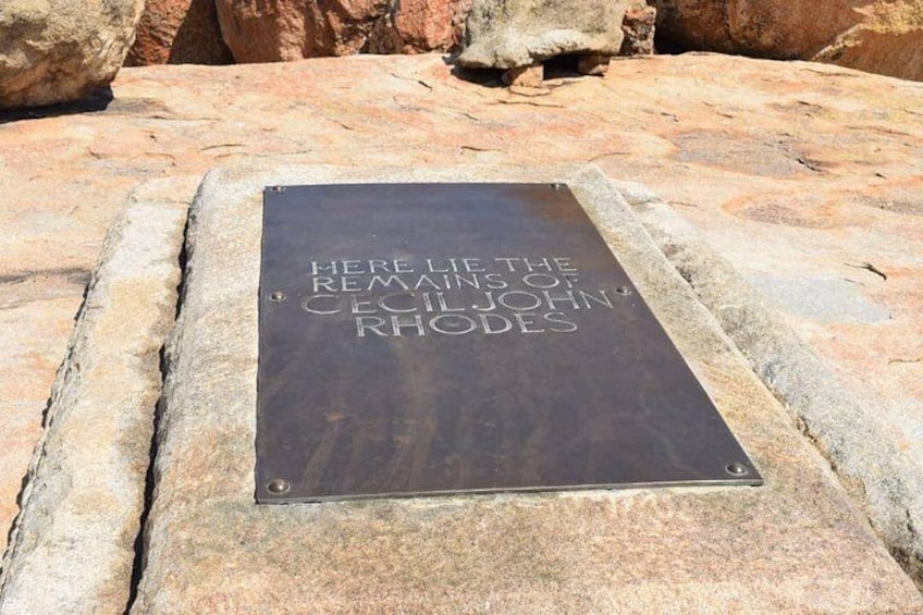 A metal plaque on a stone surface with inscriptions. 2