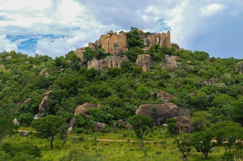 A mountainous landscape with a prominent rock formation at the peak. 5