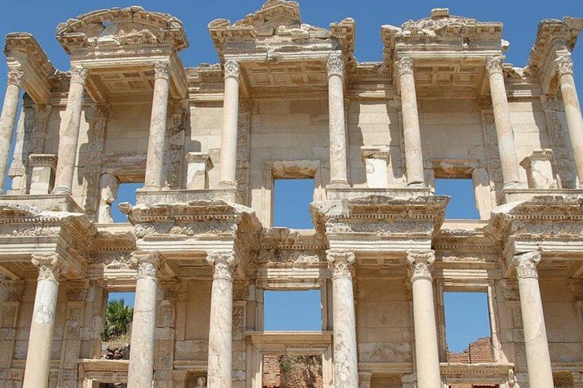 Ancient ruins with columns and intricate carvings. 1