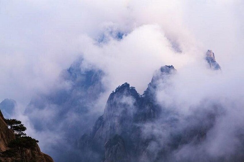 A mountain range partially obscured by clouds. 3
