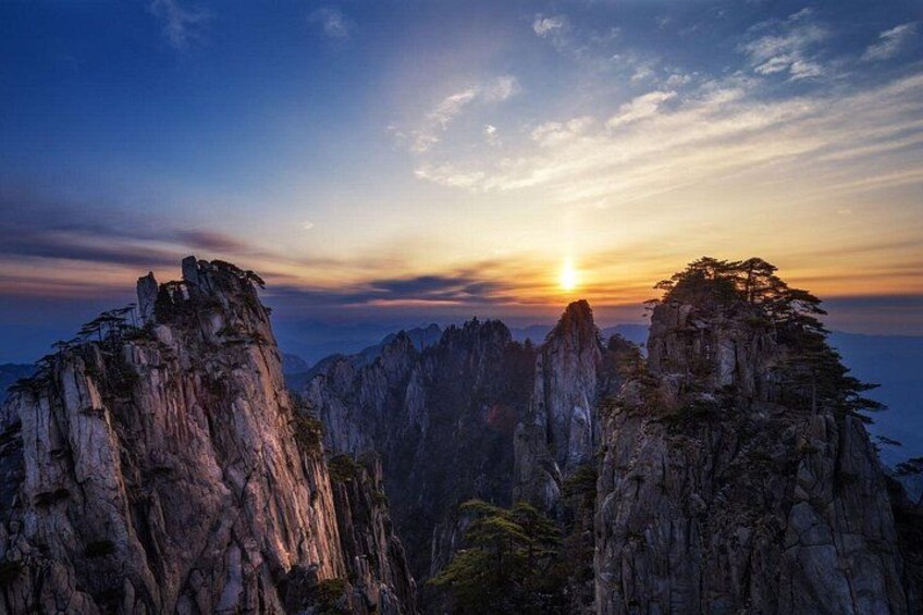 A mountainous landscape with rocky peaks and a sunset. 4