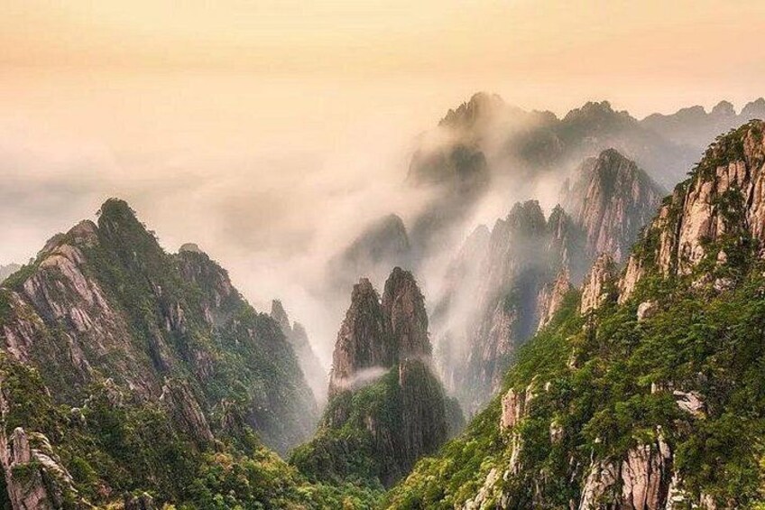A mountainous landscape with steep cliffs and lush greenery. 2