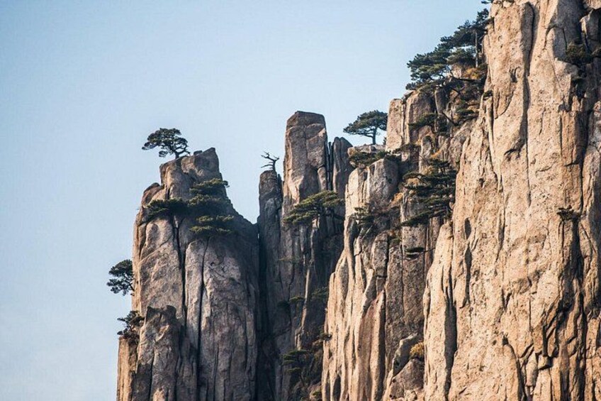 A rugged mountain landscape with prominent rock formations and sparse vegetation. 5