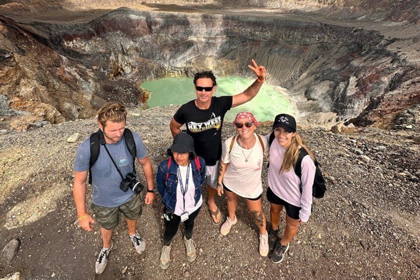A traveler is posing in front of the santa ana volcano crater 3