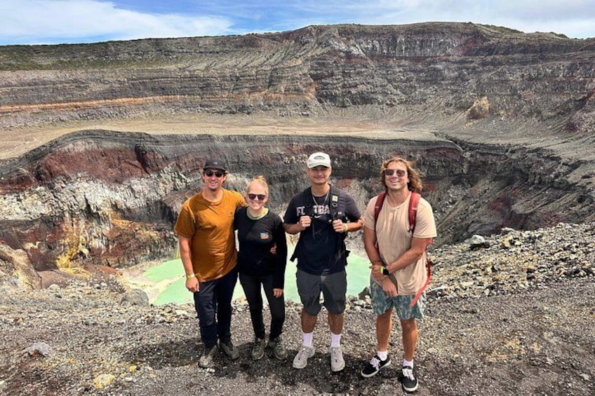 A traveler is posing in front of the santa ana volcano crater 3