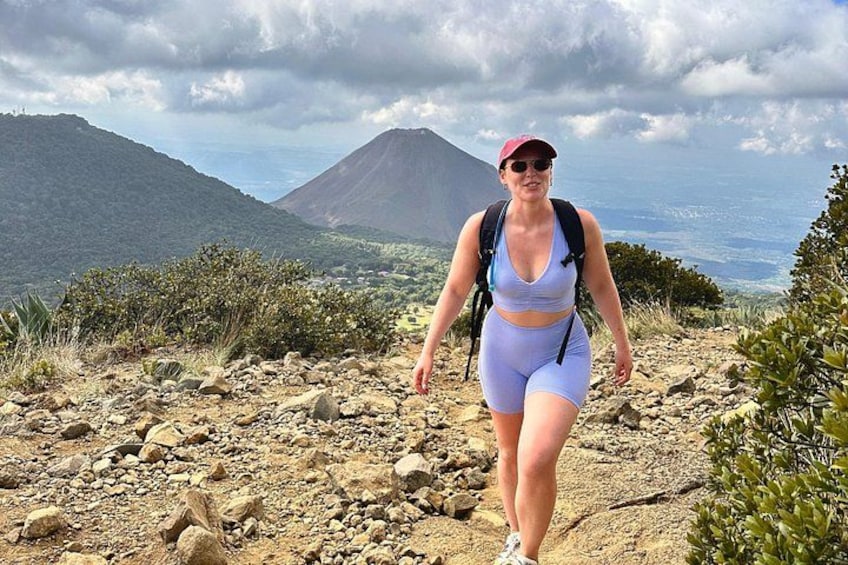 A traveler is posing in front of the santa ana volcano crater 5