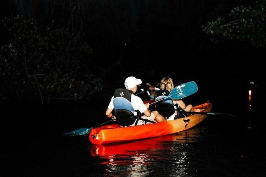 A canoe on water with people paddling. 5