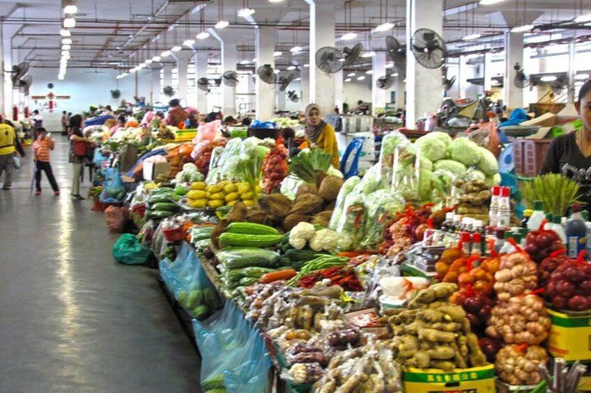 A bustling indoor market with various fresh produce and packaged goods. 5
