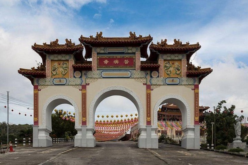 A traditional Chinese gate with intricate designs and a sign above it. 4
