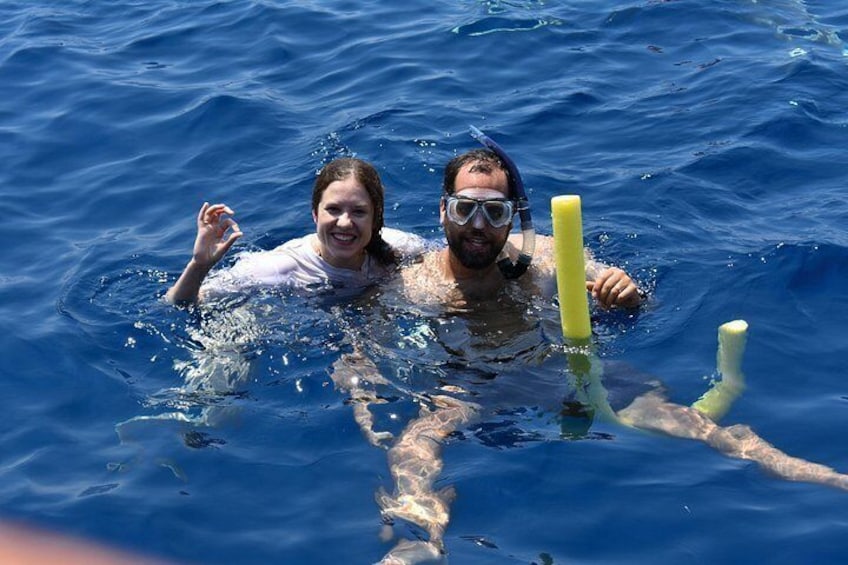 Two people swimming in the ocean with snorkels and fins. 4