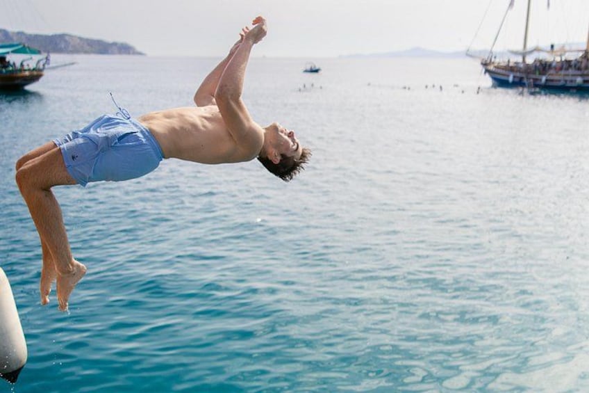 Swimming stop at Metopi: Dive into the crystal-clear waters and enjoy jumping off the boat! 5