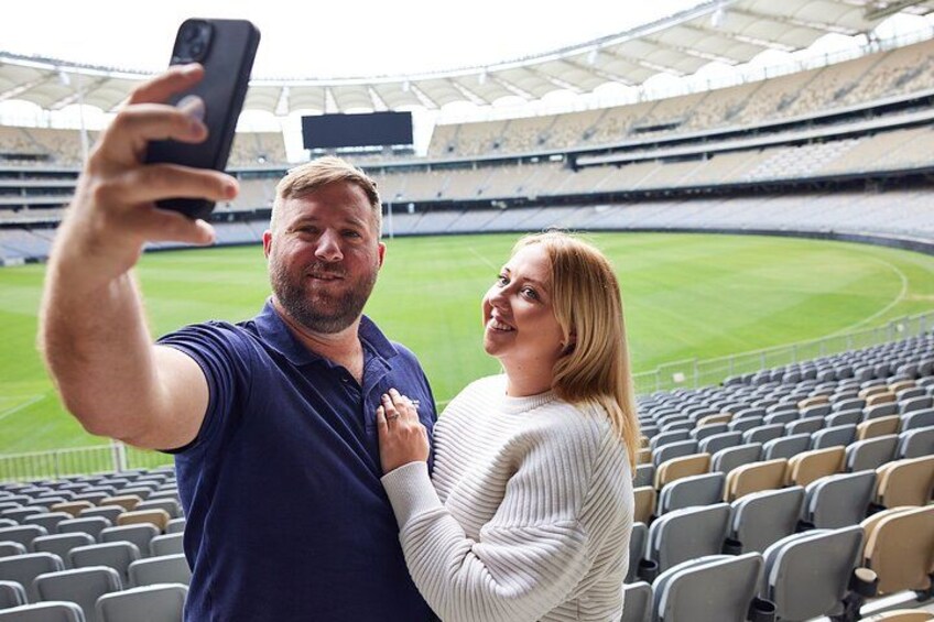 A stadium with empty seats and a person taking a selfie. 2