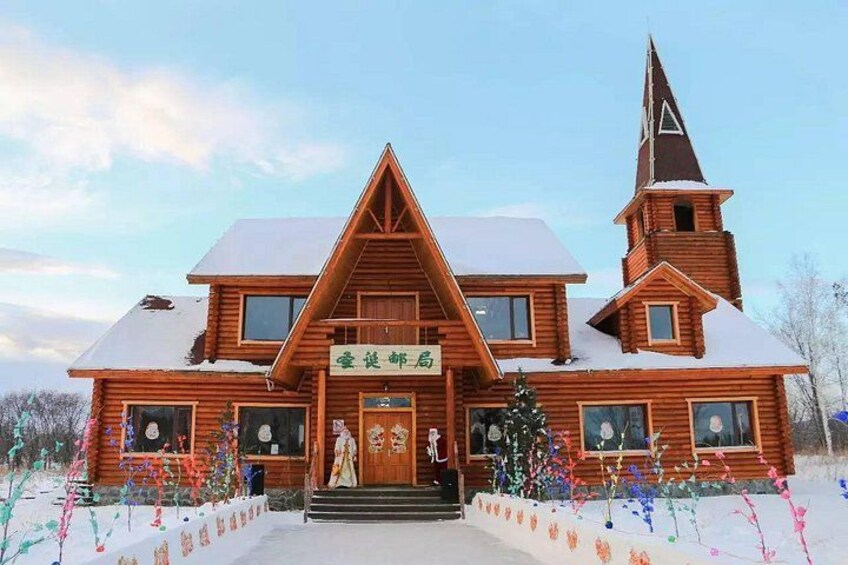 A wooden building with a steep roof and a tower. 5