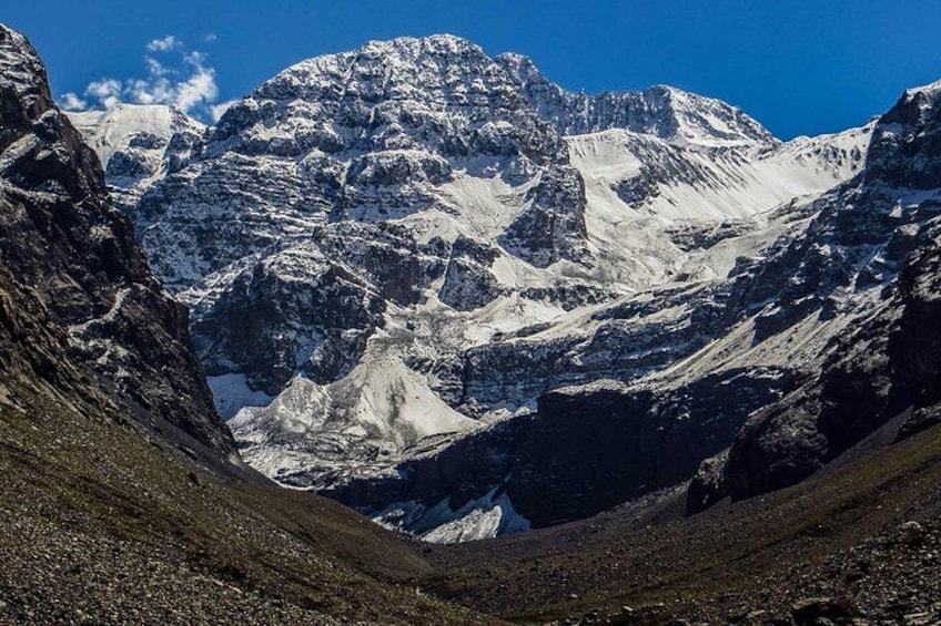 A snow-covered mountain range with rugged peaks and a valley. 4