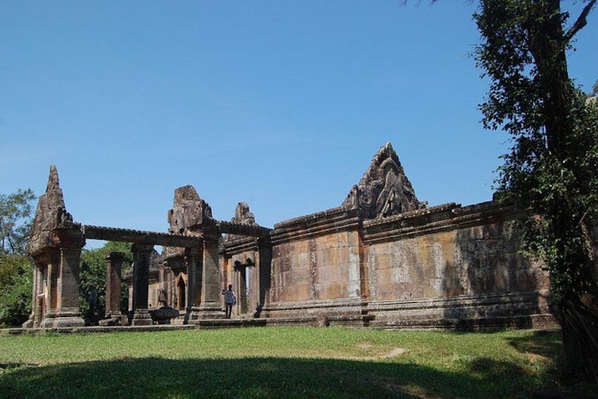 An ancient temple complex with stone structures and a clear sky. 4