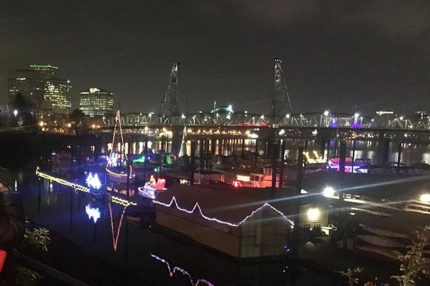 Vista nocturna de un frente marítimo con edificios iluminados y un puente. 4