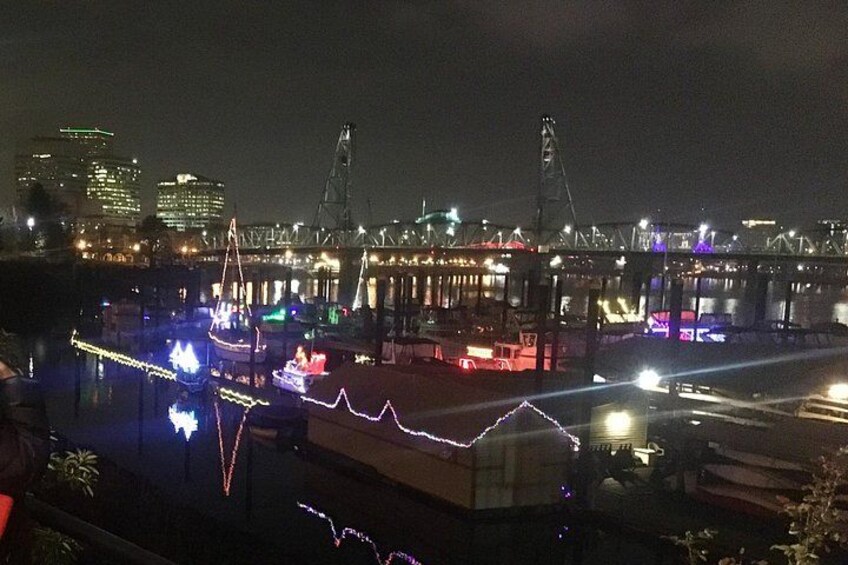 A waterfront area with illuminated buildings and a bridge structure. 3