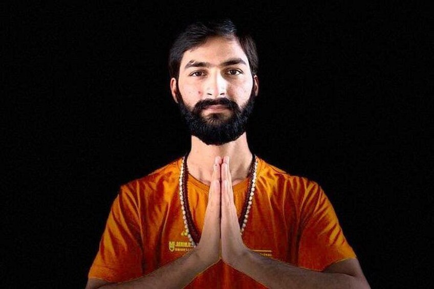 A person in an orange shirt with a prayer gesture. 1