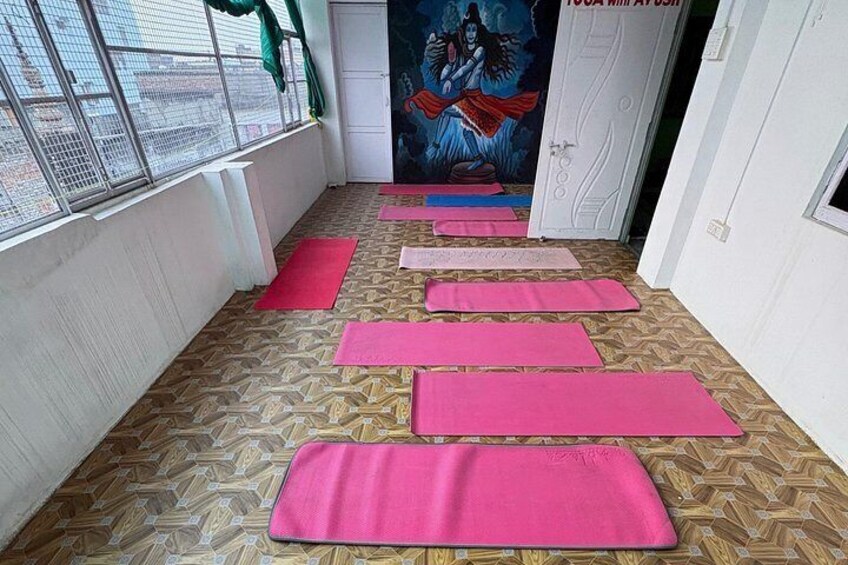 A yoga studio with mats arranged in rows. 4