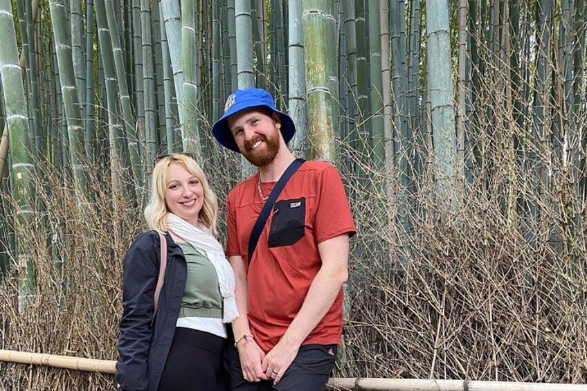 Two people standing in front of bamboo plants. 2