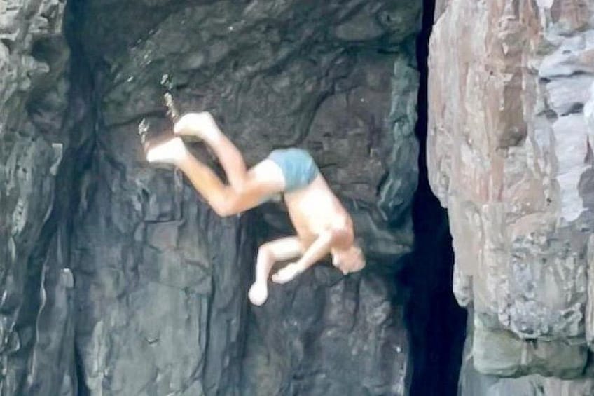 A person climbing a rock face. 2