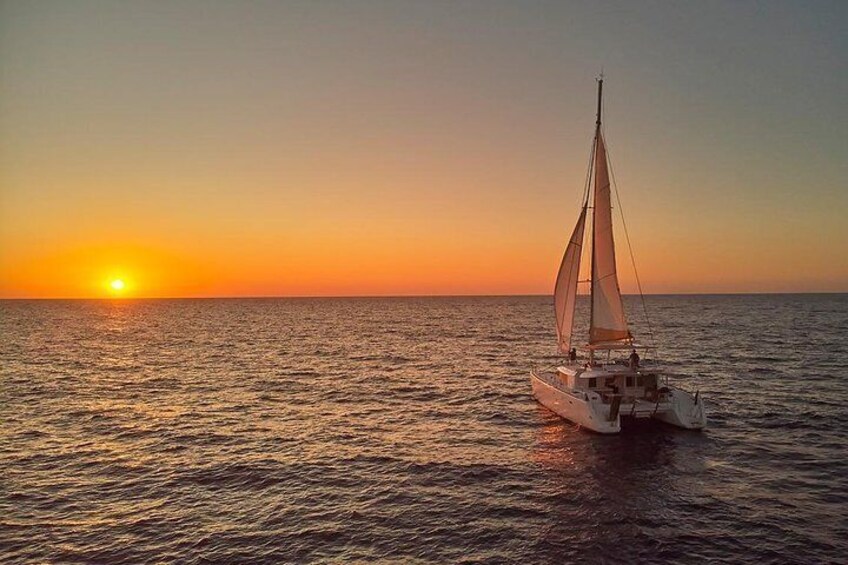 A sailboat on calm waters during sunset. 5