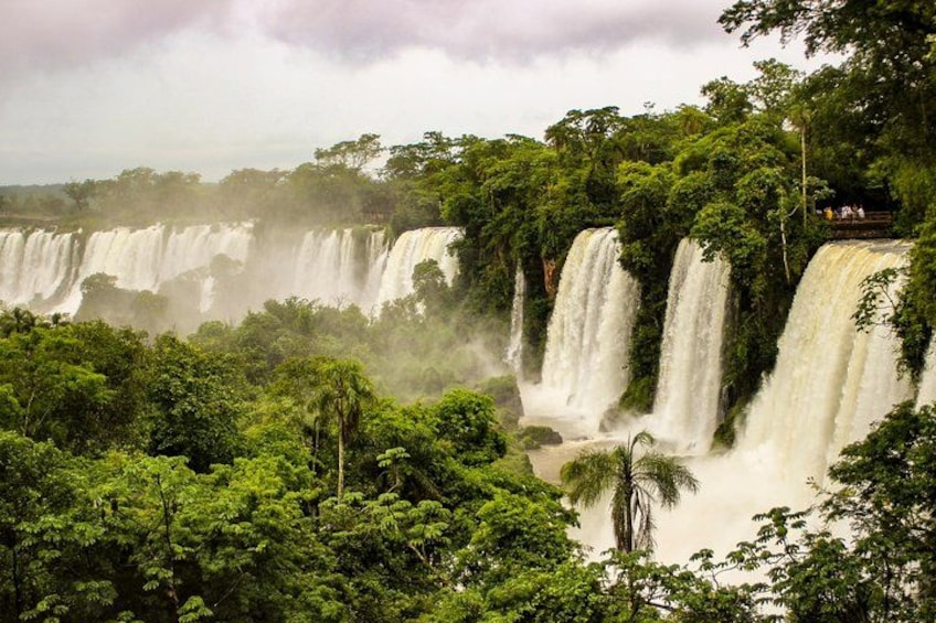 A multi-tiered waterfall surrounded by dense tropical vegetation. 2