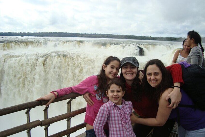 A family posing in front of a waterfall. 4