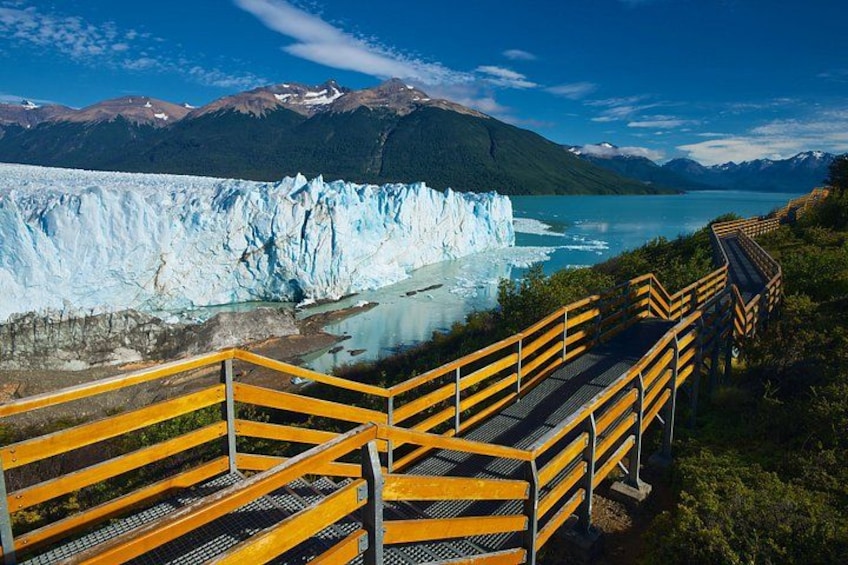 A glacier with a wooden walkway leading to it. 3
