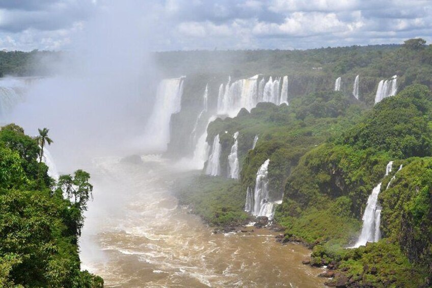 A series of waterfalls cascading down a lush, green landscape. 5