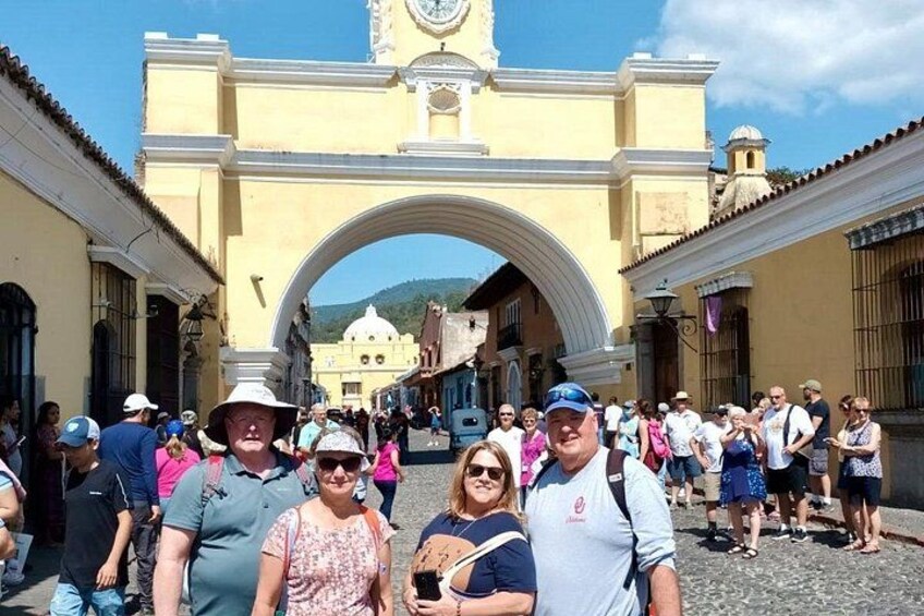 A historic archway with tourists. 3