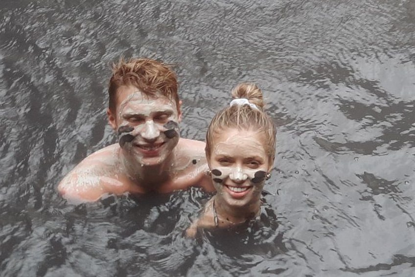 Two people in a body of water, likely a lake or river. 3
