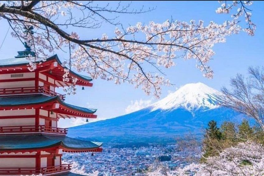 A traditional Japanese pagoda, cherry blossoms, and Mount Fuji in the background. 5