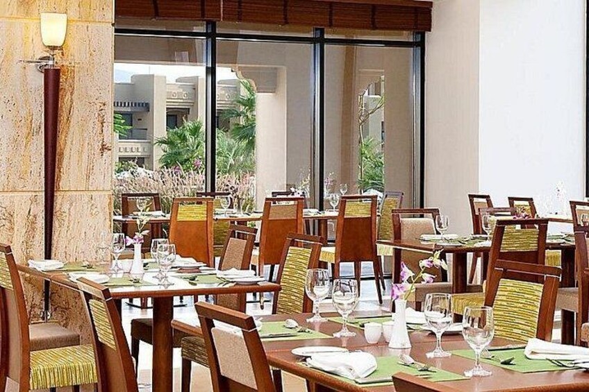 A restaurant with multiple tables, chairs, and a view of the outdoors. 3