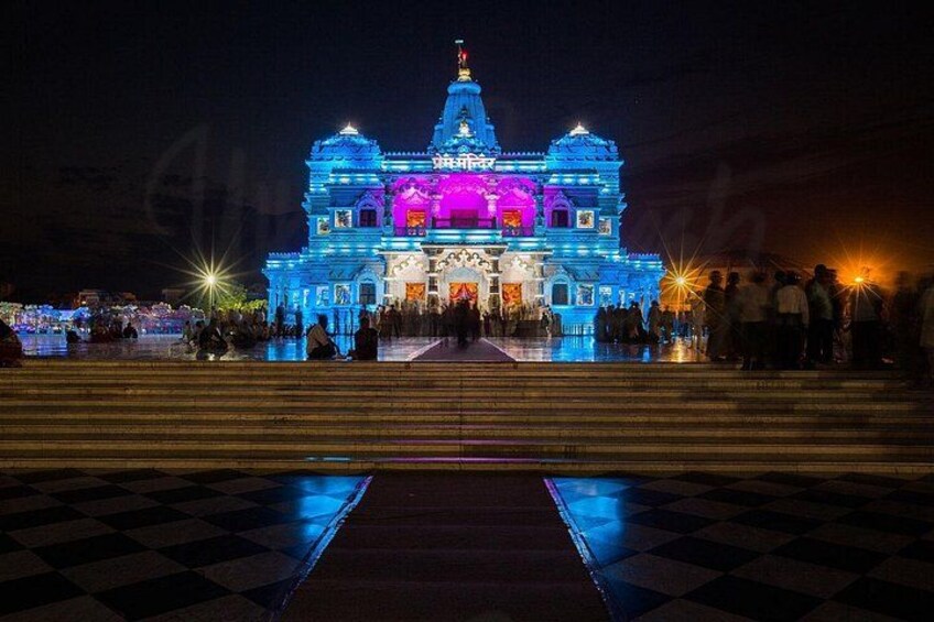 A brightly lit building with a checkered floor in front. 4