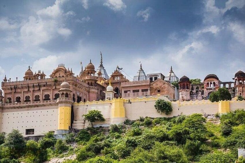 A historic building complex with domed structures and a fortified wall. 2