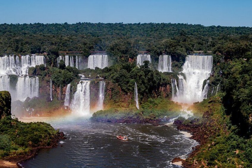 A series of waterfalls cascading down a lush, green landscape with a river in the foreground. 3