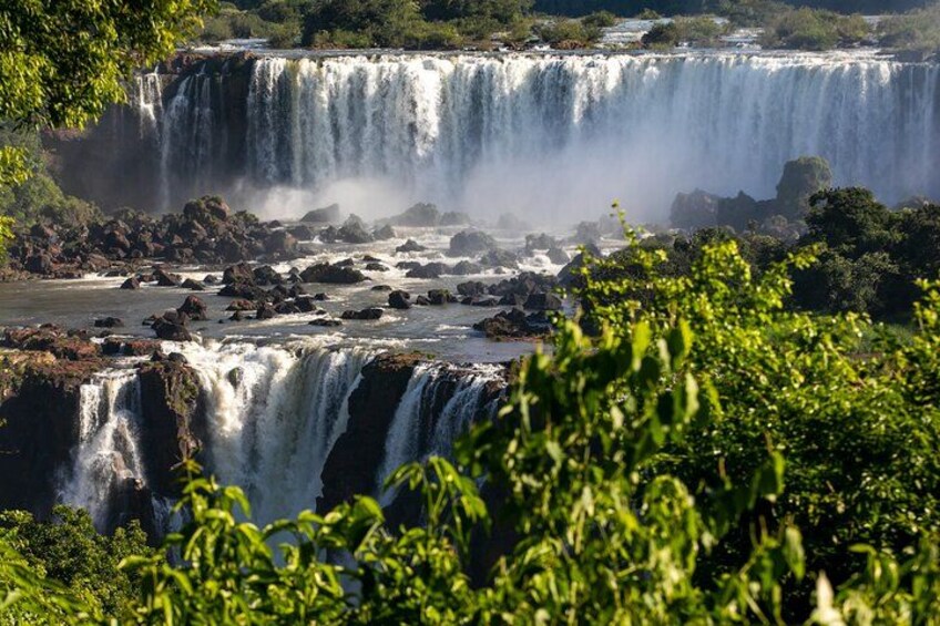 A multi-tiered waterfall surrounded by lush greenery. 4