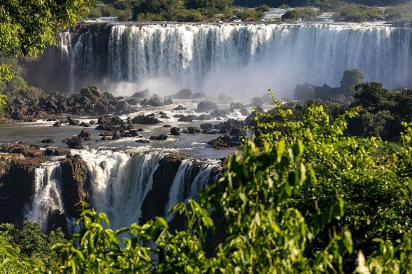 A multi-tiered waterfall surrounded by lush greenery. 4