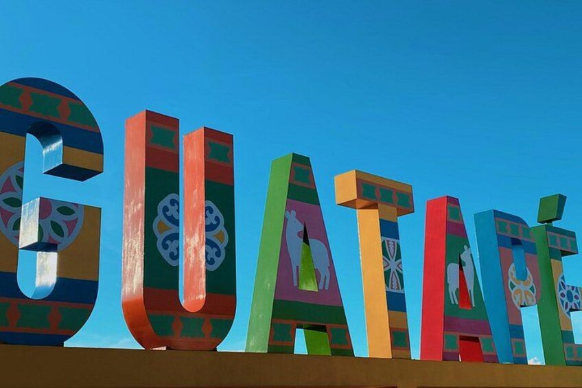 Colorful letters spelling 'GUATEMALA' against a clear blue sky. 4