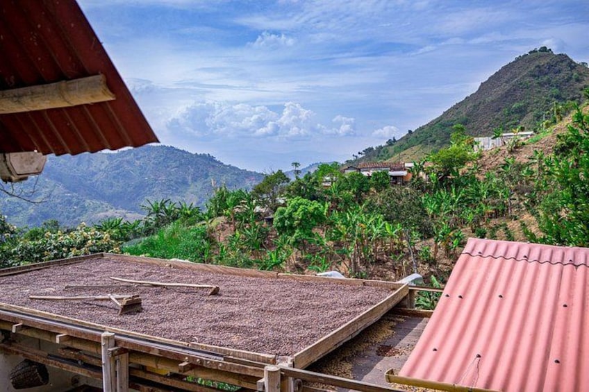 A mountainous landscape with a red-roofed structure in the foreground and a view of hills in the background. 3