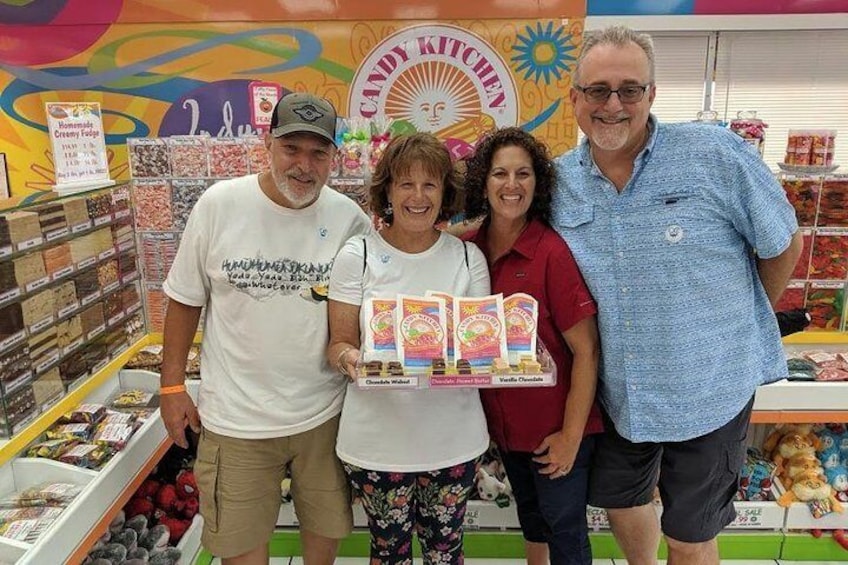 A candy store with colorful displays and a sign that reads 'CANDY KITCHEN.' 3