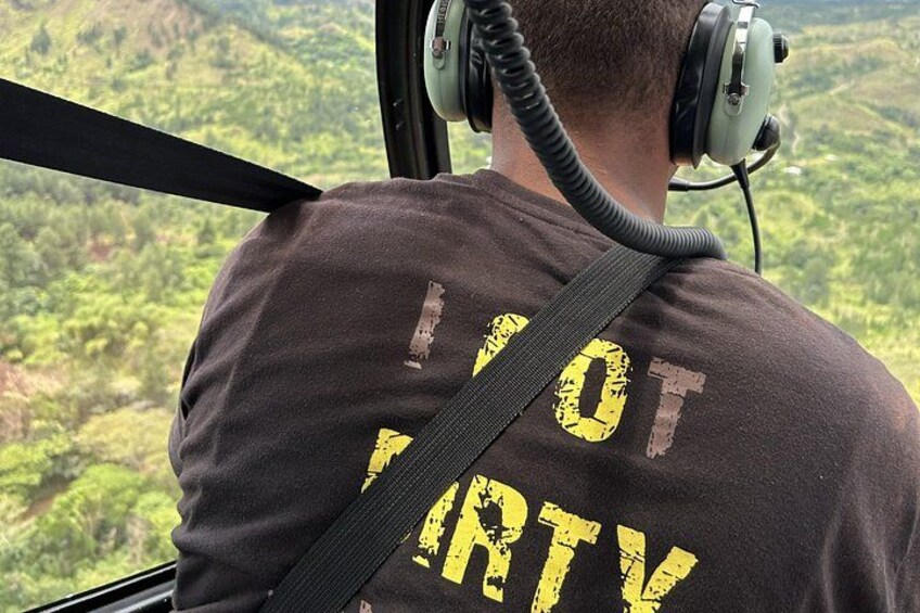 A person wearing a black shirt with yellow text and headphones. 3
