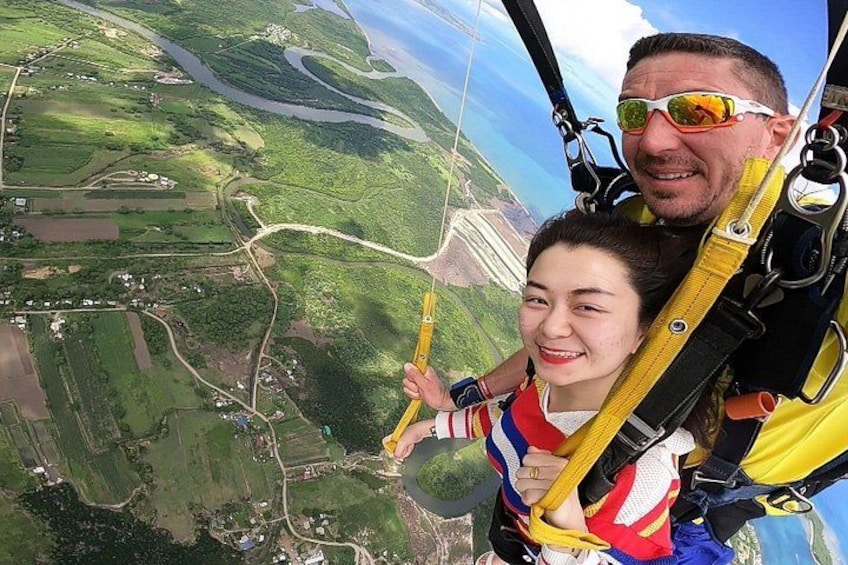 A person in a parachute harness with a landscape view below. 5