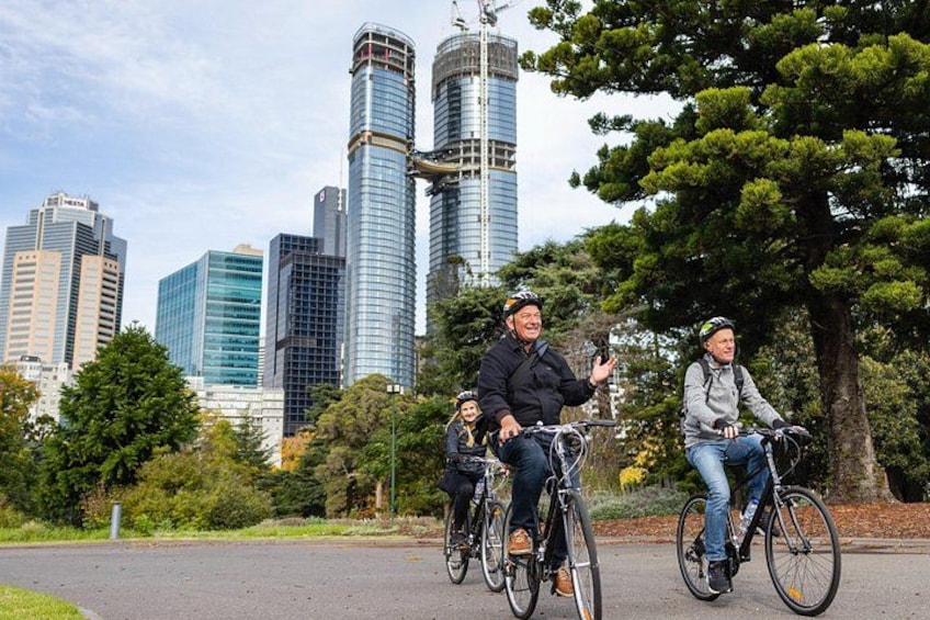 Cyclists on a path with a city skyline in the background. 2