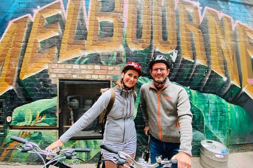 Two people standing in front of a graffiti-covered wall with the word 'FABLEUR' visible. 5